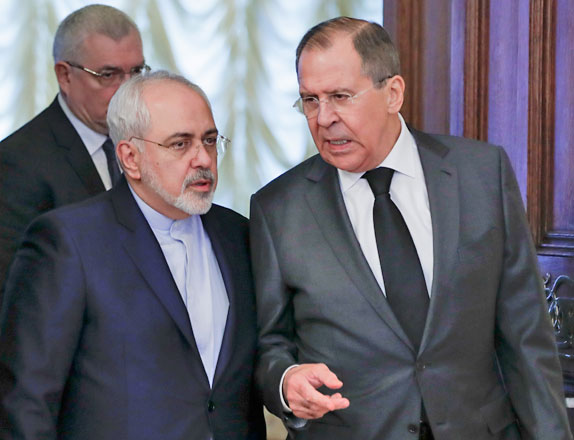 Russian Foreign Minister Sergey Lavrov (right) and Iranian Foreign Minister Mohammad Javad Zarif talk to each other as they enter a hall for the talks in Moscow, Russia, on Tuesday (AP photo)