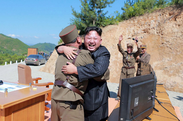 This picture taken on Tuesday and released by North Korea's official Korean Central News Agency shows North Korean leader Kim Jong-un (centre) celebrating the successful test-fire of the intercontinental ballistic missile Hwasong-14 at an undisclosed location (AFP photo)