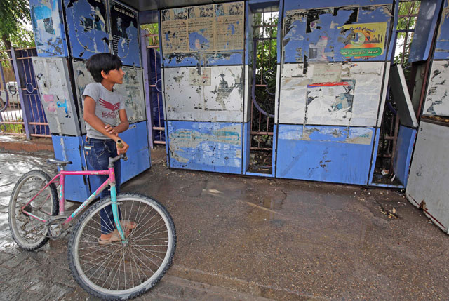 An Iraqi boy stands by the site of an overnight suicide bomb attack in Baghdad's Shiite suburb of Al Shoala on Thursday (AFP photo)