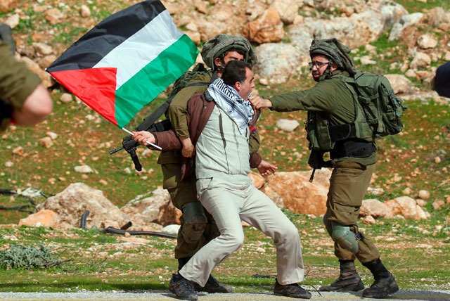 A Palestinian demonstrator is detained by Israeli soldiers during a demonstration near the West Bank village of Tubas, near the Jordan Valley, on Wednesday, against the US President Donald Trump's peace proposals (AFP photo)