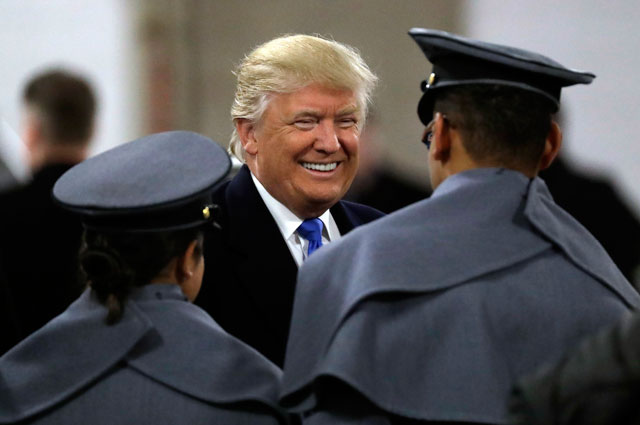 President-elect Donald Trump (centre) greets army cadets before the army-navy NCAA college football game in Baltimore on Saturday (AP photo)