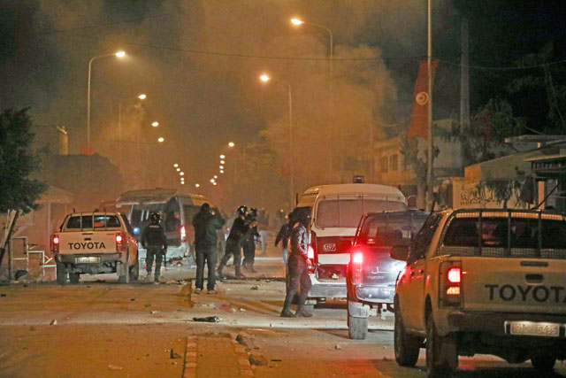Tunisian security forces take security measures during a protest against price hikes early on Monday (Anadolu Agency photo)