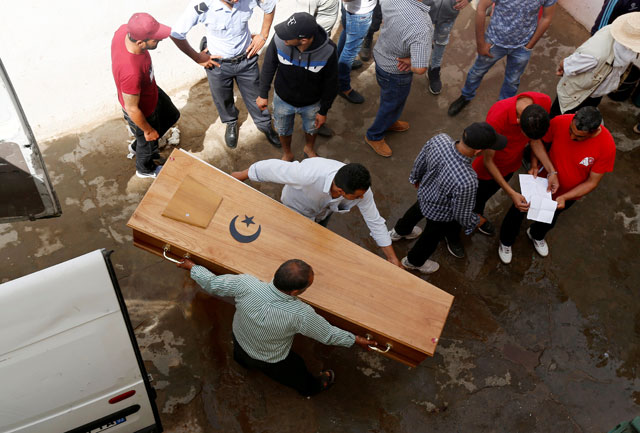 Relatives carry a coffin containing the body of an immigrant who drowned when a boat sank, at a hospital morgue in Sfax, Tunisia, on Monday (Reuters photo)