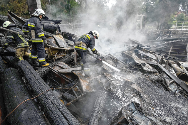 Firefighters douse the rubble of a restaurant complex destroyed by a missile strike in the second largest Ukrainian city of Kharkiv, on Sunday, amid the Russian invasion of Ukraine (AFP photo)