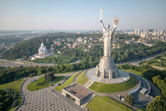 This aerial view taken on Sunday shows steeplejacks installing the coat of arms of Ukraine on the shield of the 62 metre Motherland Monument in Kyiv, amid the Russian invasion of Ukraine (AFP photo)