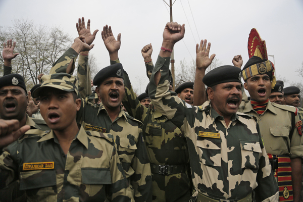 Indian Border Security Force soldiers shout slogans during a wreath-laying ceremony of their slain colleague on the outskirts of Srinagar, Indian-controlled Kashmir, on Sunday (AP photo)