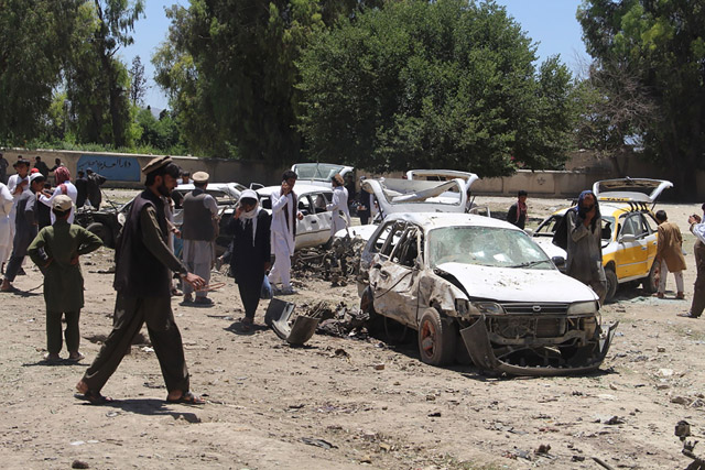 Afghan residents gather at the scene of a suicide car bomb that targeted a CIA-funded pro-government militia force at a public bus station in Khost province, on Saturady (AFP photo)
