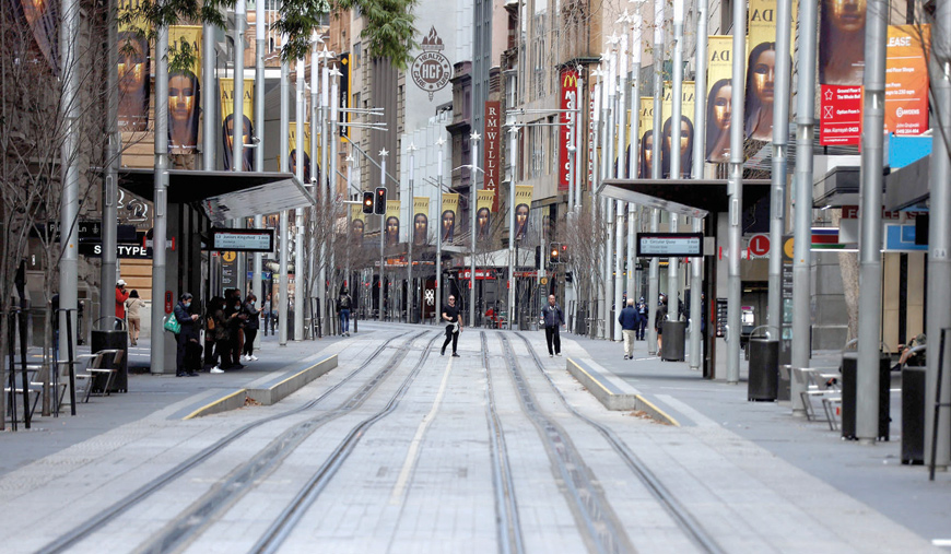 A man makes his way through a quiet street in the central business district of Sydney on Saturday, as authorities race to contain an emerging outbreak of the Delta strain (AFP photo)