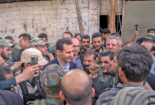 This handout photo released by the official Facebook page of the Syrian presidency on Sunday shows Syrian President Bashar Assad (centre) talking with government troops in Eastern Ghouta, in the leader's first trip to the former rebel enclave outside Damascus in years (AFP photo)