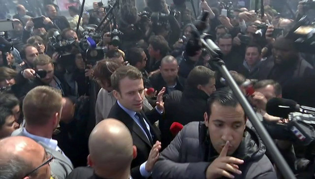 A still image taken from video shows Emmanuel Macron (centre), head of the political movement En Marche !, or Onwards !, and candidate for the 2017 French presidential election, talking to Whirlpool employees in front of the company plant in Amiens, France, on Wednesday (Reuters photo)