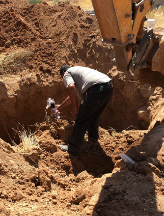 A joint team from Miyahuna and WAJ, escorted by security forces, removes an illegal pipe in the Jiza District on Thursday (Photo courtesy of Water Ministry)