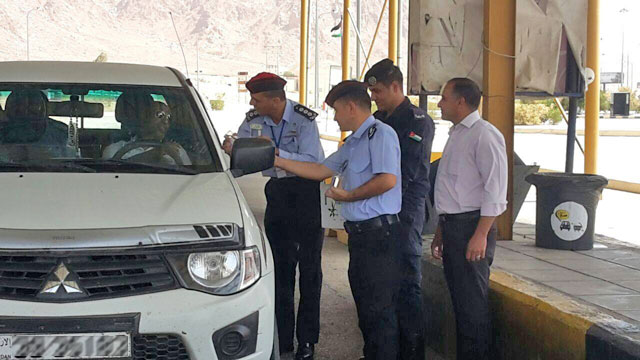 Police officers distribute water bottles to motorists near the southern city of Aqaba on Tuesday (Photo courtesy of Amen FM)
