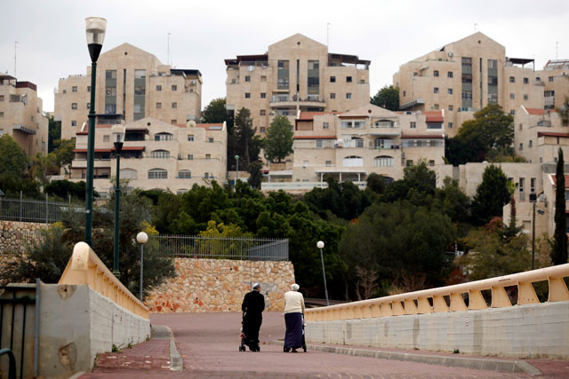 Two people walk in the Israeli settlement of Maale Edumim, in the occupied West Bank on Saturday (Reuters photo)