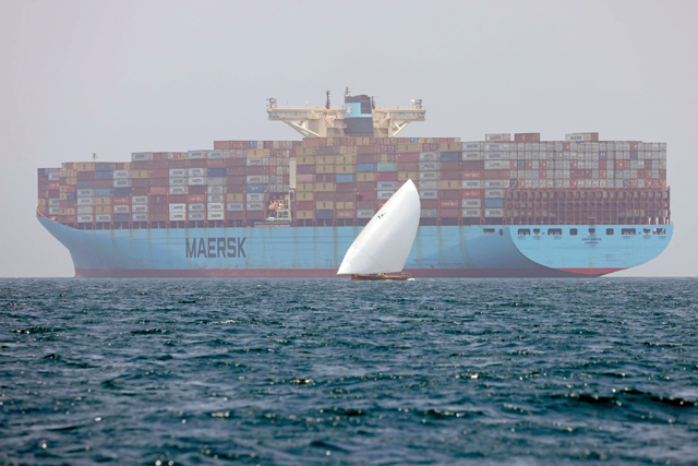Sailors pass by the Ebba Maersk container ship as they participate in the annual long-distance dhow sailing race, known as  Al Gaffal, near Sir Abu Nuair Island towards the Gulf emirate of Dubai on June 4, 2022.  (AFP photo)