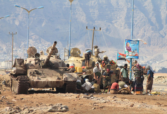 Loyalists of exiled Yemeni President Abed Rabbo Mansour Hadi gather next to tanks on a road on the outskirts of the southern city of Aden, in April, 2015 (AFP photo)