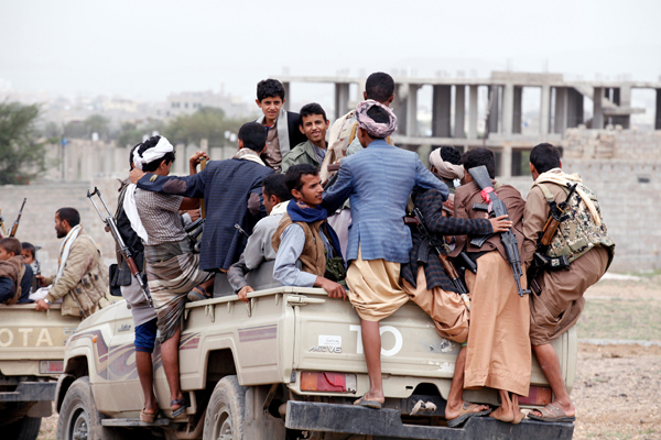 Tribesmen loyal to the Houthi movement ride on the back of a truck as they leave a tribal gathering they held to show support to a political council formed by the movement and the General People's Congress Party to unilaterally rule Yemen by both groups in Sanaa, on Sunday (Reuters photo)