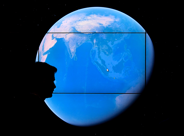 A man looks at a Google Earth map on a screen as Google Earth unveils the revamped version of the application April 18, 2017, at an event at New York's Whitney Museum of Art (AFP file photo)