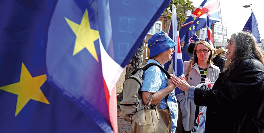 Anti-Brexit, pro-European Union supporters, carry placards and EU and Union Jack flags as they wait outside Dover Town Hall in Dover, southeast England, on Friday, where businesswoman, campaigner and author Gina Miller launched a nationwide campaign calling to ‘End The Chaos’ of Brexit (AFP Photo)