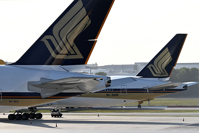 This photo taken on March 16, 2020 shows Singapore Airlines planes parked on the tarmac at Changi International Airport in Singapore (AFP photo)