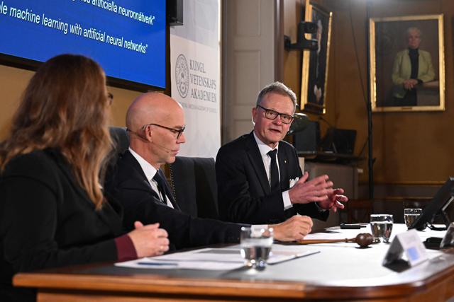 Secretary General of the Royal Swedish Academy of Sciences Hans Ellegren (centre) and Chair of the Nobel Committee for Physics Ellen Moons (left) listen as member of the Nobel Committee for Physics Anders Irbaeck addresses media representatives following their announcement of the 2024 Nobel Prize in Physics at the Royal Swedish Academy of Sciences in Stockholm, Sweden, on Tuesday (AFP photo)