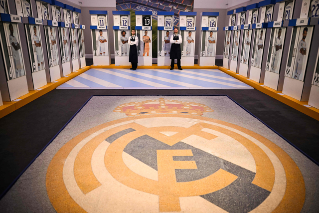 Sotheby's Members of staff stand among Real Madrid’s first-team changing room lockers from Santiago Bernabeu Stadium in Madrid, during the auction press preview, at Sotheby's auction house, in central London, on Wednesday (AFP photo)