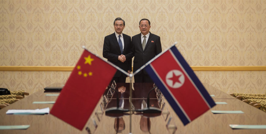 China's Foreign Minister Wang Yi (left) shakes hands with North Korea's Foreign Minister Ri Yong Ho at the Mansudae Assembly Hall in Pyongyang on Wednesday (AFP photo)