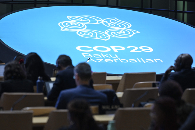 Participants listen to speeches during the United Nations Climate Change Conference in Baku on Wednesday (AFP photo)