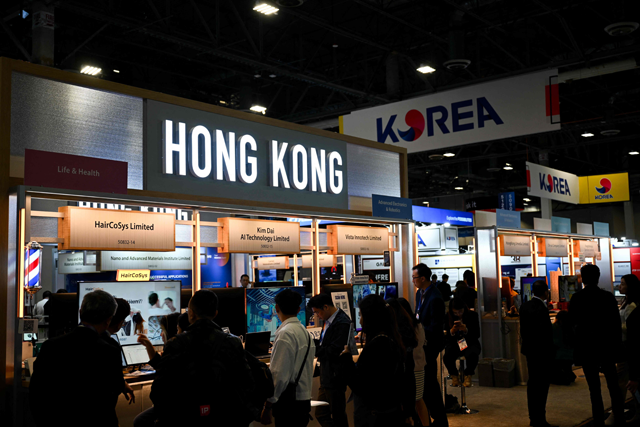 Attendees visit booths from technology companies from Hong Kong, China and South Korea during the Consumer Electronics Show (CES) in Las Vegas, Nevada on Tuesday (AFP photo)