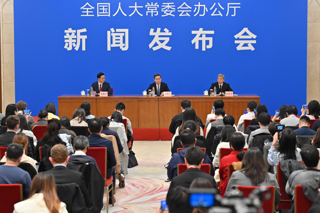 China's Minister of Finance Lan Foan speaks next to vice Chairman of the NPC Financial and Economic Committee, and Director of the NPCSC Budget Work Committee Xu Hongcai, during a press conference in Beijing on Friday (AFP photo)