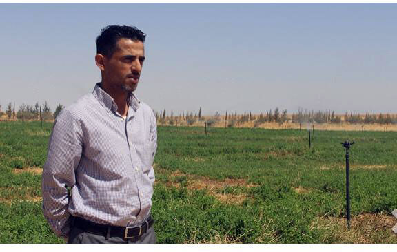Mohammad Al Fayaz poses for a photo on his fodder farm (Photo courtesy of Reem Rawashdeh)