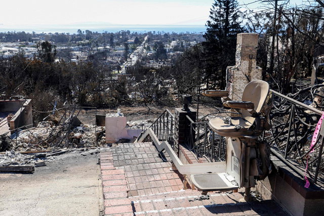 A charred stair lift is seen at a house destroyed by the Palisades Fire, on Tuesday, in the Pacific Palisades neighbourhood of Los Angeles  (AFP photo)