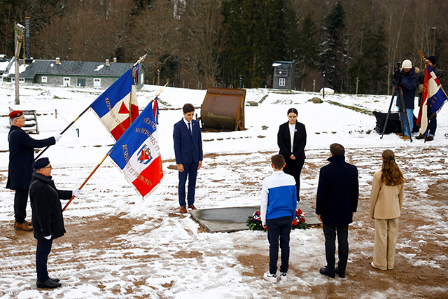 French President Emmanuel Macron (foreground second right) stands in respect during a memorial tour at the site of the Natzweiler-Struthof World War II concentration camp, eastern France, on Saturday (AFP photo)