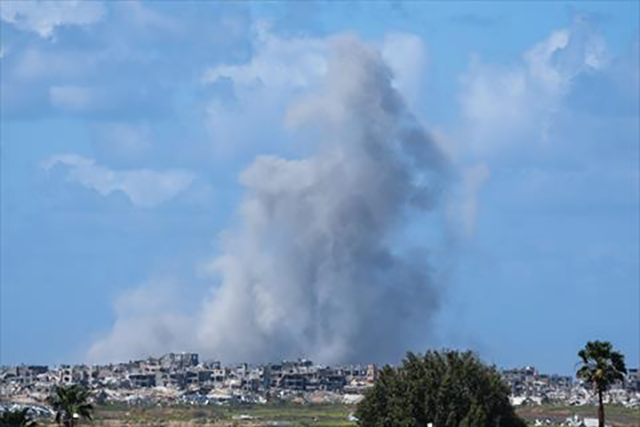 In this photo, taken from Israel's southern border with the Gaza Strip, smoke rises over destroyed buildings in northern Gaza on Wednesday  (AFP photo)