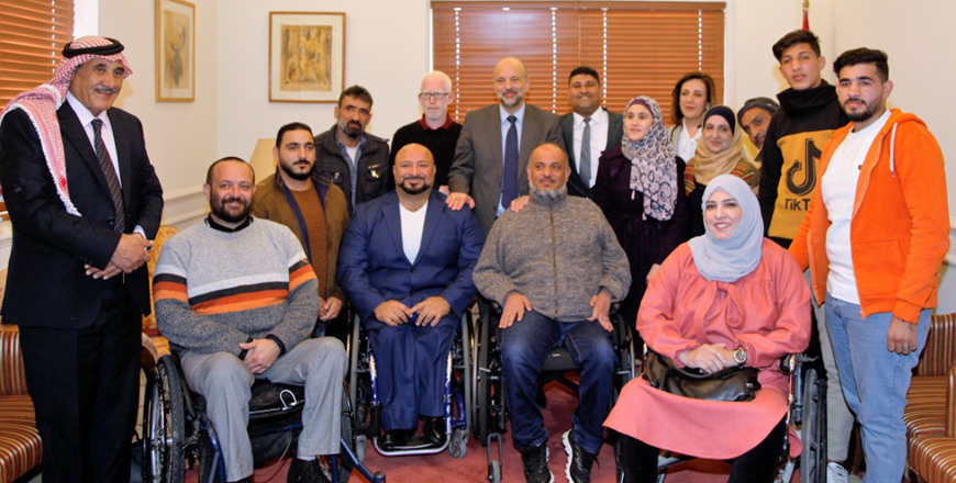   Prime Minister Omar Razzaz meets with a group of citizens with disabilities and listens to their requests and needs on Tuesday (Petra photo)