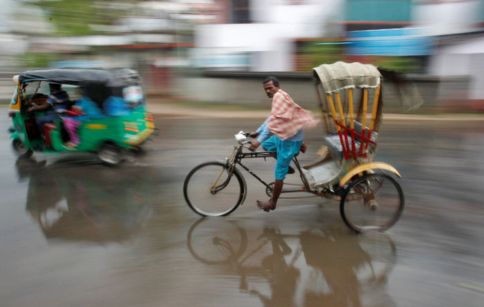 A man pedals his cycle rickshaw during rains in Agartala, India, on Saturday (Reuters photo)