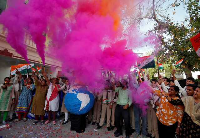 Teachers and students release coloured smoke as they celebrate after India shot down one of its satellites in space with an anti-satellite missile in a test, inside their school premises in Ahmedabad, India, on Wednesday (Reuters photo)