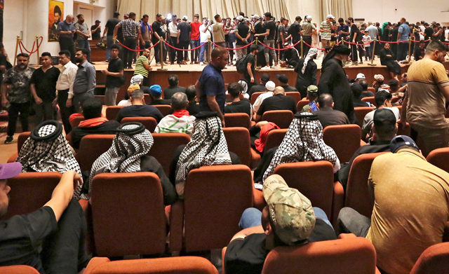 Supporters of the Iraqi cleric Moqtada Sadr gather inside the great conference hall at the parliament in the capital Baghdad's high-security Green Zone, as they continue their sit-in to protest a rival bloc's nomination for prime minister, on Tuesday (AFP photo)