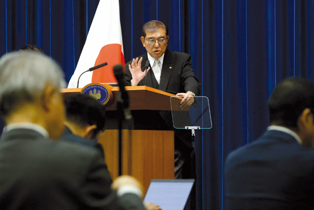 Japan's Prime Minister Shigeru Ishiba (C) attends a press conference at the prime minister's office in Tokyo on Monday (AFP Photo)
