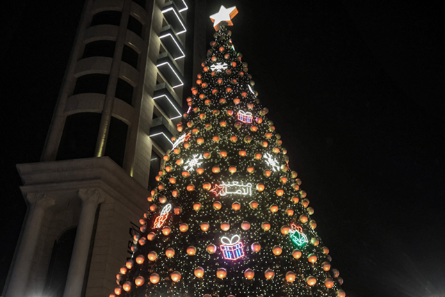 A decoration in Arabic reading ‘restoring hope’ is lit up on the Christmas tree during the lighting ceremony in Sassine Square in the Ashrafieh district of Lebanon’s capital Beirut, on Wednesday (AFP photo)