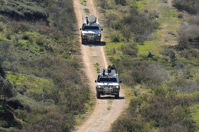 A photo taken from the southern Lebanese area of Marjayoun, shows UNIFIL forces patrolling a road near the southern Lebanese village of Kfar Kila today (AFP photo)