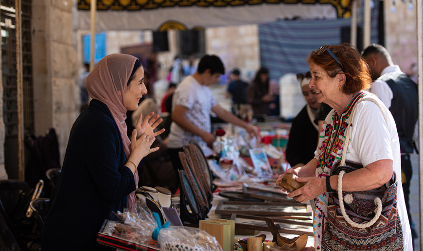 A visitor is seen at a booth during the Festival of Encounter at the Greek Catholic Church Our Lady of Fatima on Friday (Photo courtesy of Rajiv Raman/JRS Jordan)