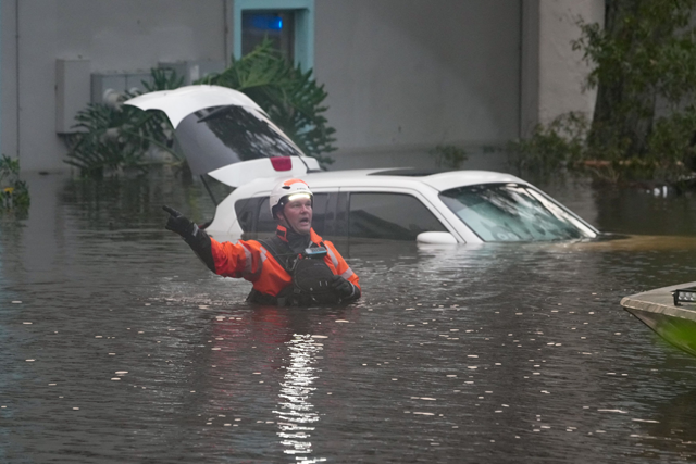 First responders in the water outside an apartment complex that was flooded from and overflowing creek due to Hurricane Milton on Thursday (AFP photo)