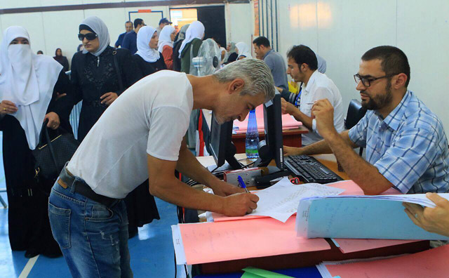 A voter registers to vote at a polling station in Amman on Tuesday (Photo by Osama Aqarbeh)