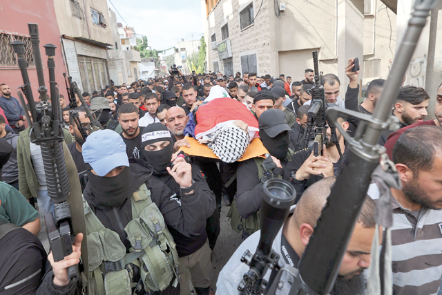 Palestinian mourners carry the body of a youth who was reportedly killed during a raid by Israeli forces on Monday in the West Bank city of Jenin (AFP photo)