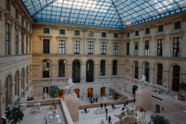 Visitors look at statues inside the Cour Marly at the Louvre Museum in Paris on Thursday (AFP photo)