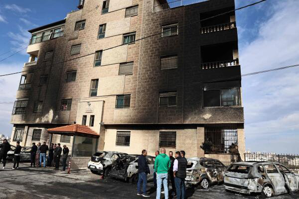 Aftermath of the settler attack: burned out cars and a building's scorched facade (AFP photo)