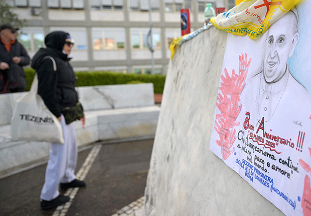 A picture shows a portrait of Pope Francis drew by school children at the statue of John Paul II outside the Gemelli hospital where Pope Francis is hospitalized with pneumonia, in Rome today (AFP photo)