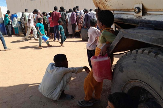People queue for water in Omdurman, the Sudanese capital's twin city (AFP photo)