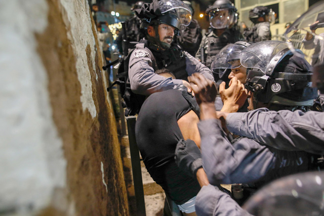 Israeli forces detain a Palestinian protester in Jerusalem's Old City on Sunday (AFP photo)