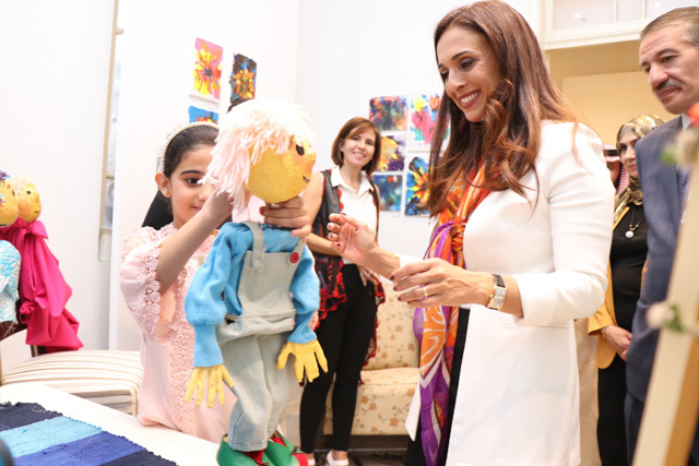 HRH Princess Rahma interacts with a young artist at the First Tarabot Art Exhibition in Amman on Wednesday (Photo courtesy of the Tarabot Community Centre)